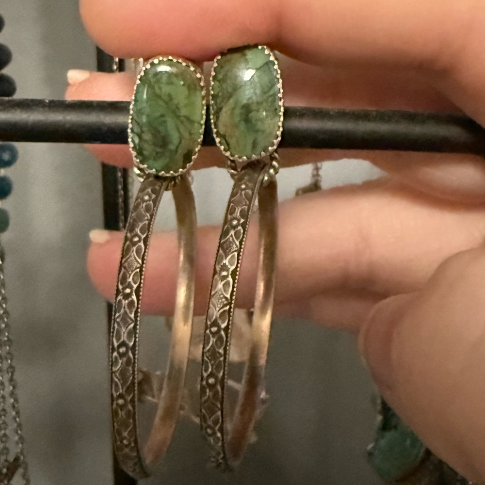 Handmade artisan sterling silver hoop earrings. I believe the stone is jade.